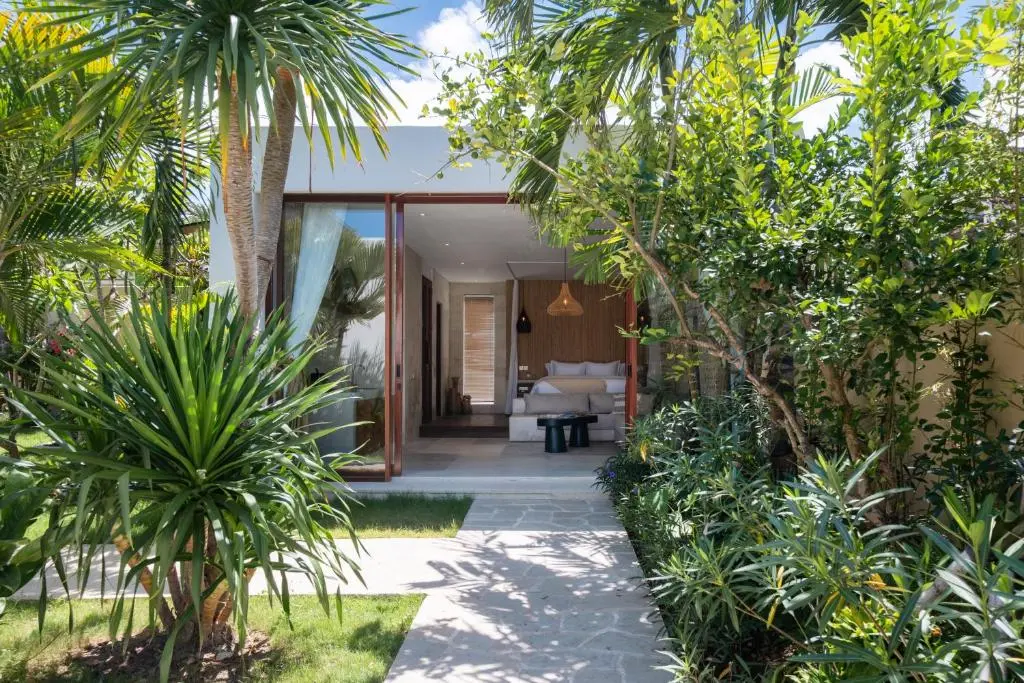 Garden path leading to the open Garden Pavilion suite among palms