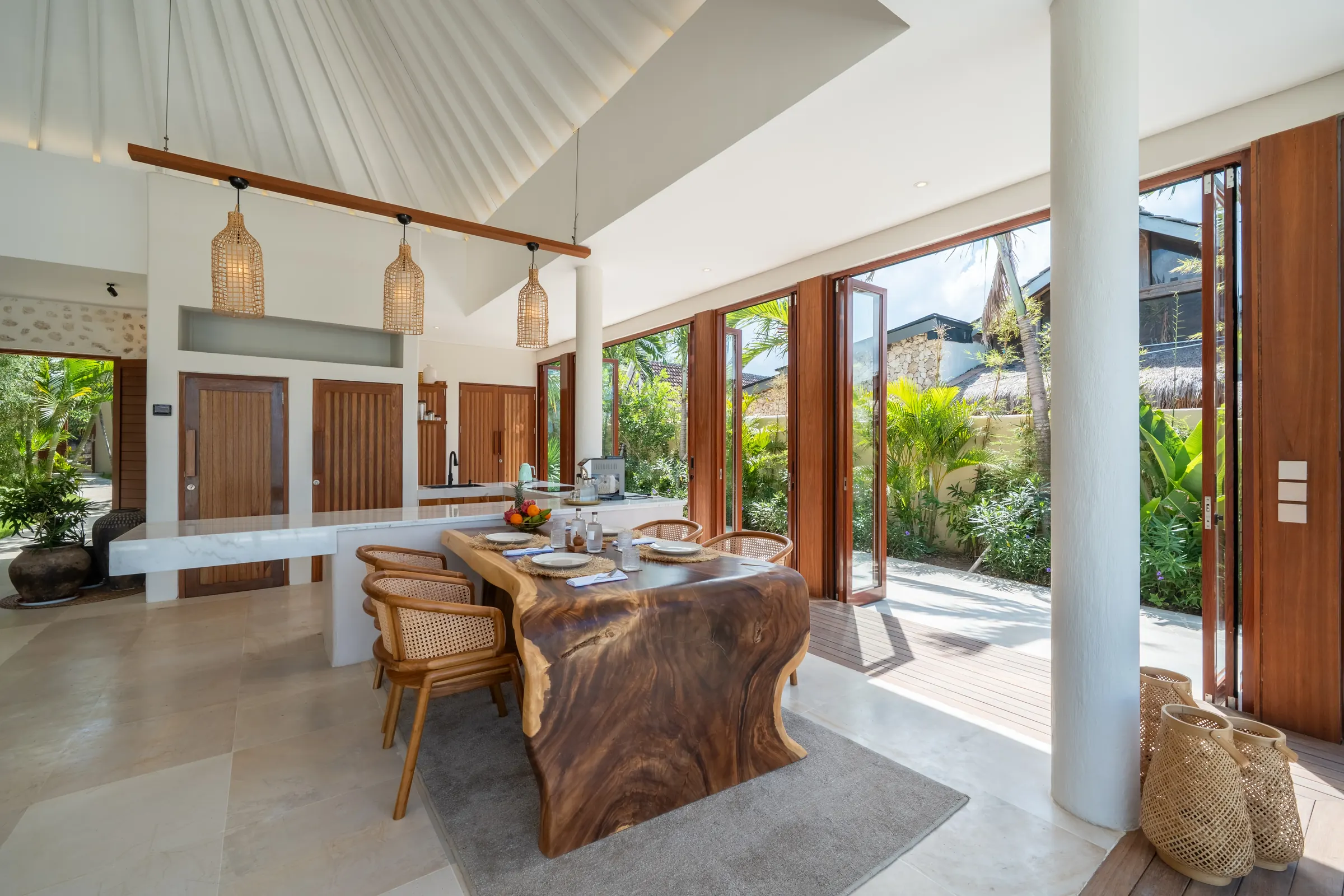 Long dining table with rattan pendants