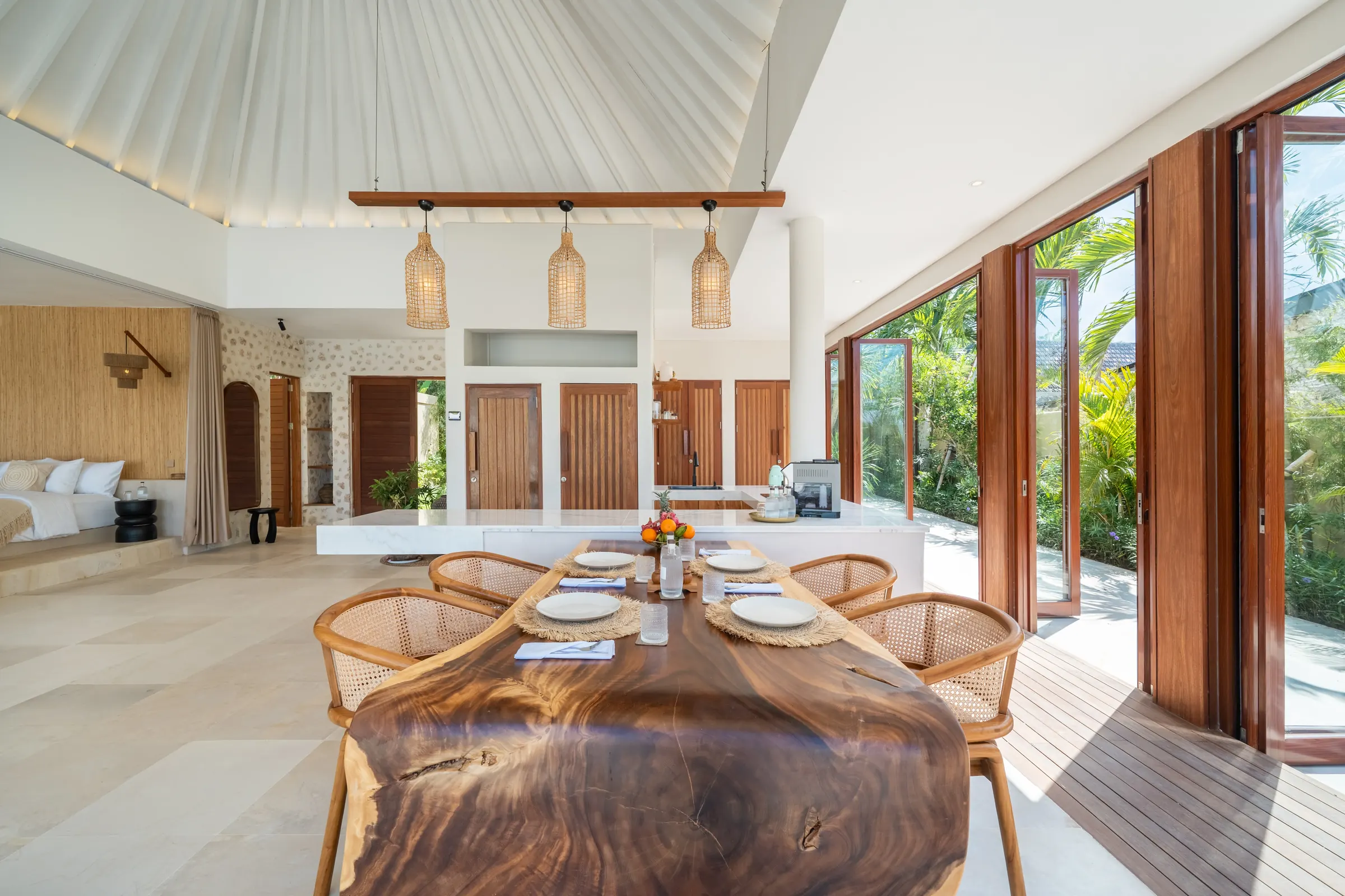 Open dining room under a soaring roof with a sea view