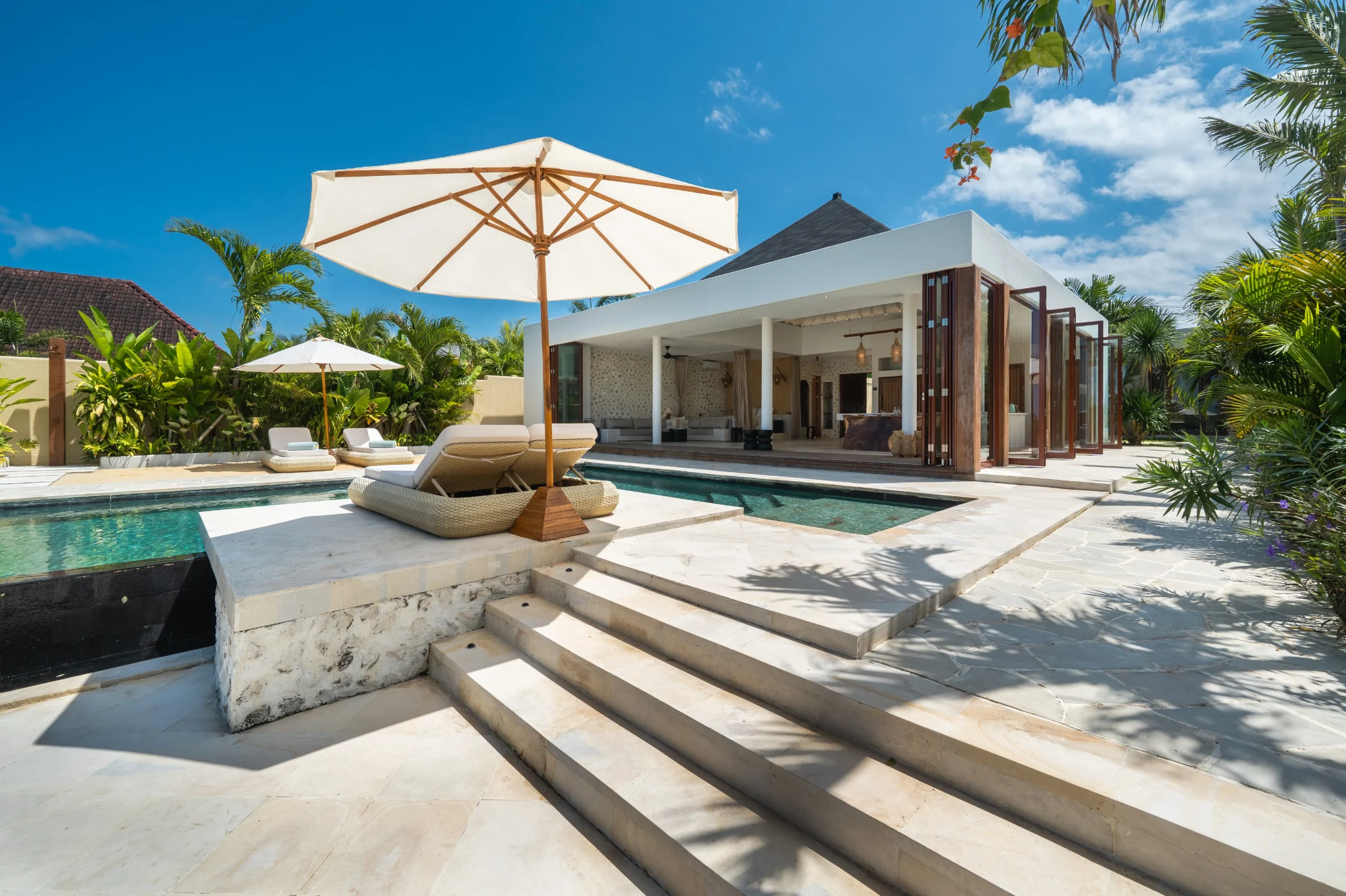 Villa Kingfisher pool and open pavilion above the turquoise bay
