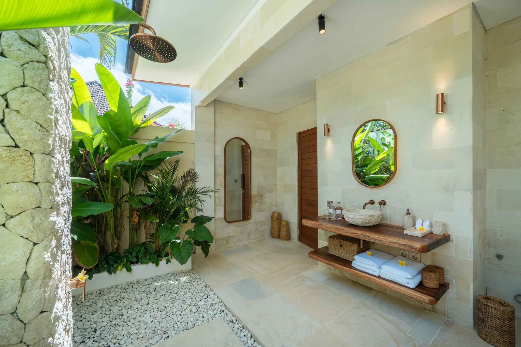 Bathroom vanity framed by greenery